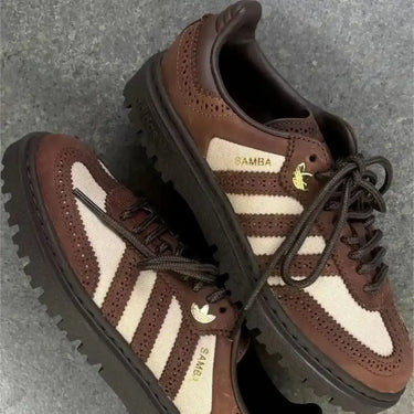 Trendy brown leather Adidas Samba sneakers with canvas panels, perfect for matching with denim for a relaxed yet polished man style.