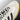 Side profile view of the Adidas Gazelle Indoor White Black Gum shoes, showing the premium leather upper, contrasting black three stripes, and gold metallic branding details.
