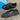 Triple black Adidas Samba trainers with a glossy snakeskin effect on the leather upper, matching black serrated three stripes, and a durable black rubber outsole.